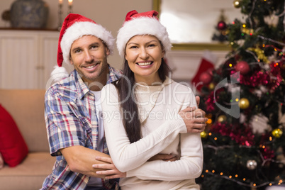 Smiling couple in cuddling on the couch