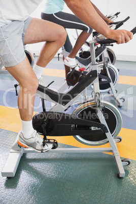 Fit people working out on the exercise bikes