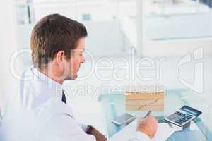 Businessman working on his finances at his desk