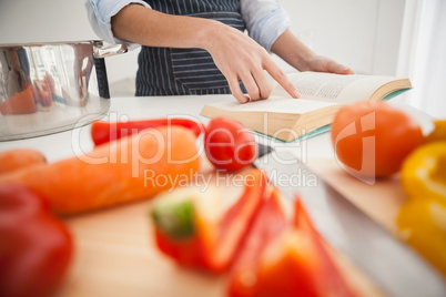 Woman following a recipe in book