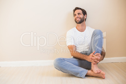 Happy man sitting on floor