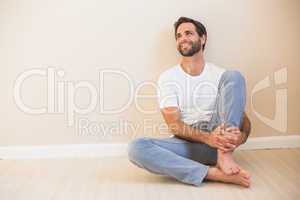 Happy man sitting on floor