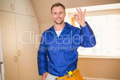 Handyman smiling at camera in tool belt