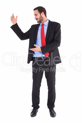 Smiling businessman holding something with his hands