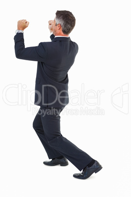 Businessman in suit pushing with his fists