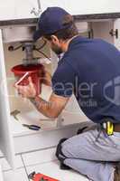 Plumber fixing under the sink