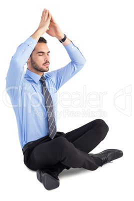 Calm businessman sitting in lotus pose with hands together