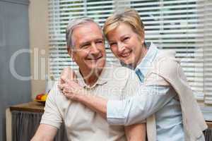 Senior couple smiling at the camera together