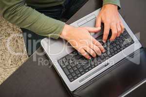 High angle view of a man typing on laptop