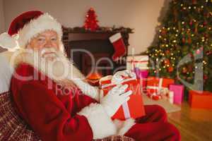 Smiling santa claus holding gift