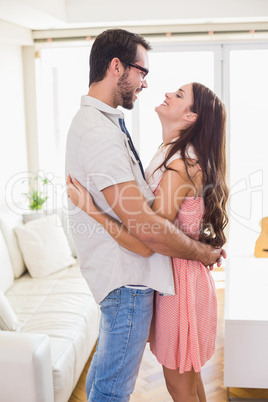 Hipster couple smiling and hugging