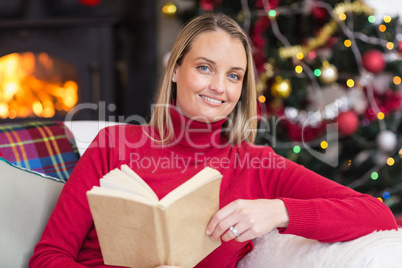 Smiling blonde reading on the couch