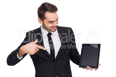 Happy businessman pointing with his tablet