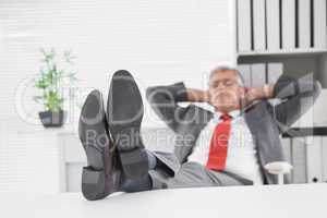 Relaxed businessman with his feet up