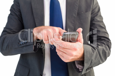 Businessman sending a text message