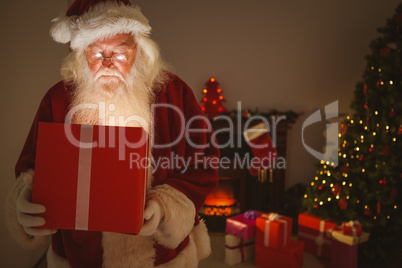 Santa claus delivering a glowing gift