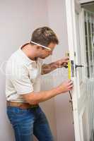 Construction worker using measuring tape