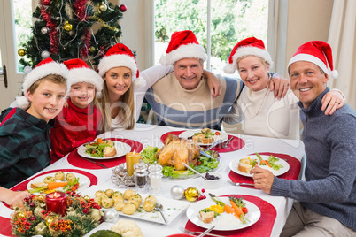 Portrait of smiling family sitting together at christmas dinner