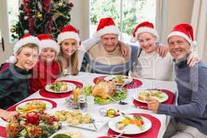 Portrait of smiling family sitting together at christmas dinner