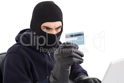 Burglar using credit card and laptop