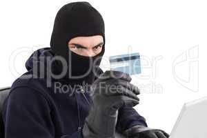 Burglar using credit card and laptop