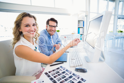 Attractive photo editor pointing at the screen