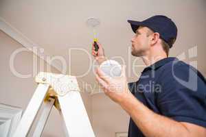 Handyman installing smoke detector