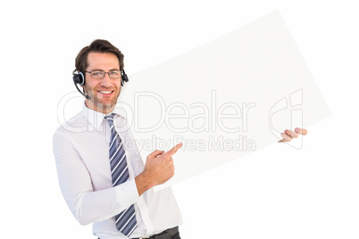 Businessman with headphone showing card to camera