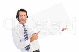 Businessman with headphone showing card to camera
