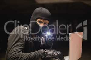 Hacker using laptop to steal identity