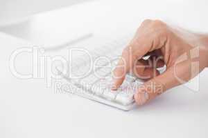 Businessman pushing key on keyboard