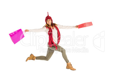 Happy brunette jumping with gifts bags