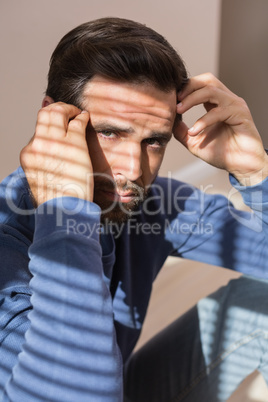 Depressed man sitting on floor