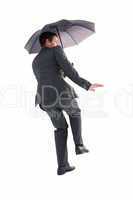 Businesswoman in suit holding umbrella