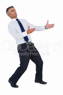 Businessman in suit posing with arms out