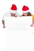 Festive couple showing a poster