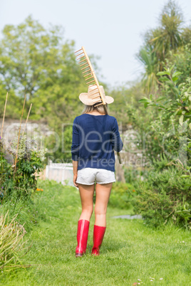 Gardening blonde holding a rake