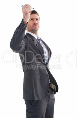 Serious businessman holding a marker and writing