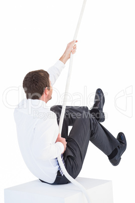 Businessman pulling a rope with effort