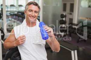 Fit man taking a break in the weights room