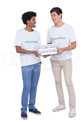 Young smiling volunteers collecting donations