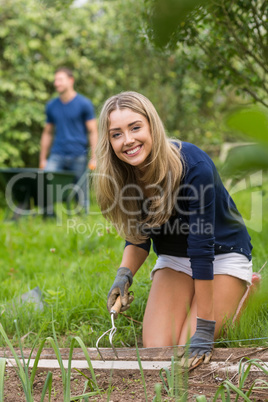 Cute couple gardening on sunny day