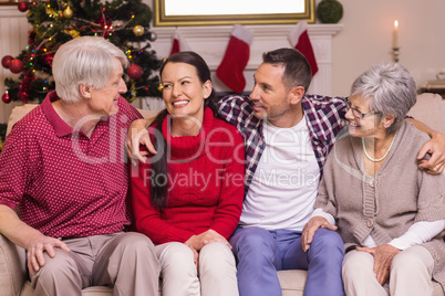 Portrait of a happy family sitting and speaking on sofa