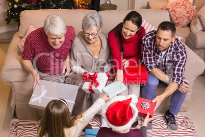 Happy family exchanging gifts at christmas