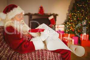 Santa claus writing his list on scroll