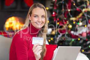 Blonde shopping online with laptop at christmas