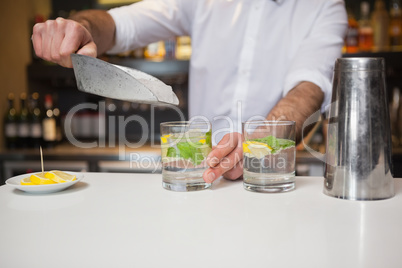 Happy bartender making a cocktail