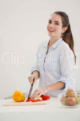 Pretty brunette slicing up peppers