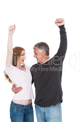 Casual couple cheering and smiling