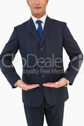 Mid section of a businessman in suit with hands out